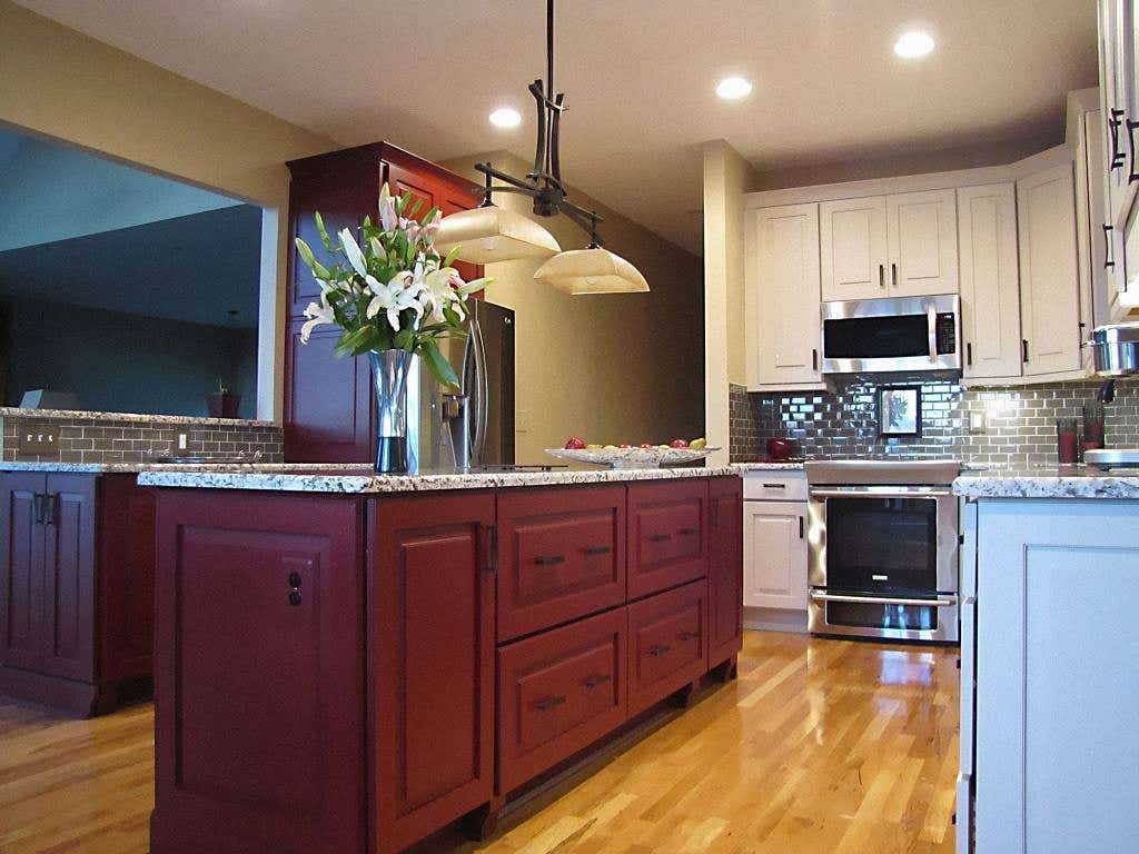 kitchen island built of raised-panel painted garnet cabinets with furniture feet